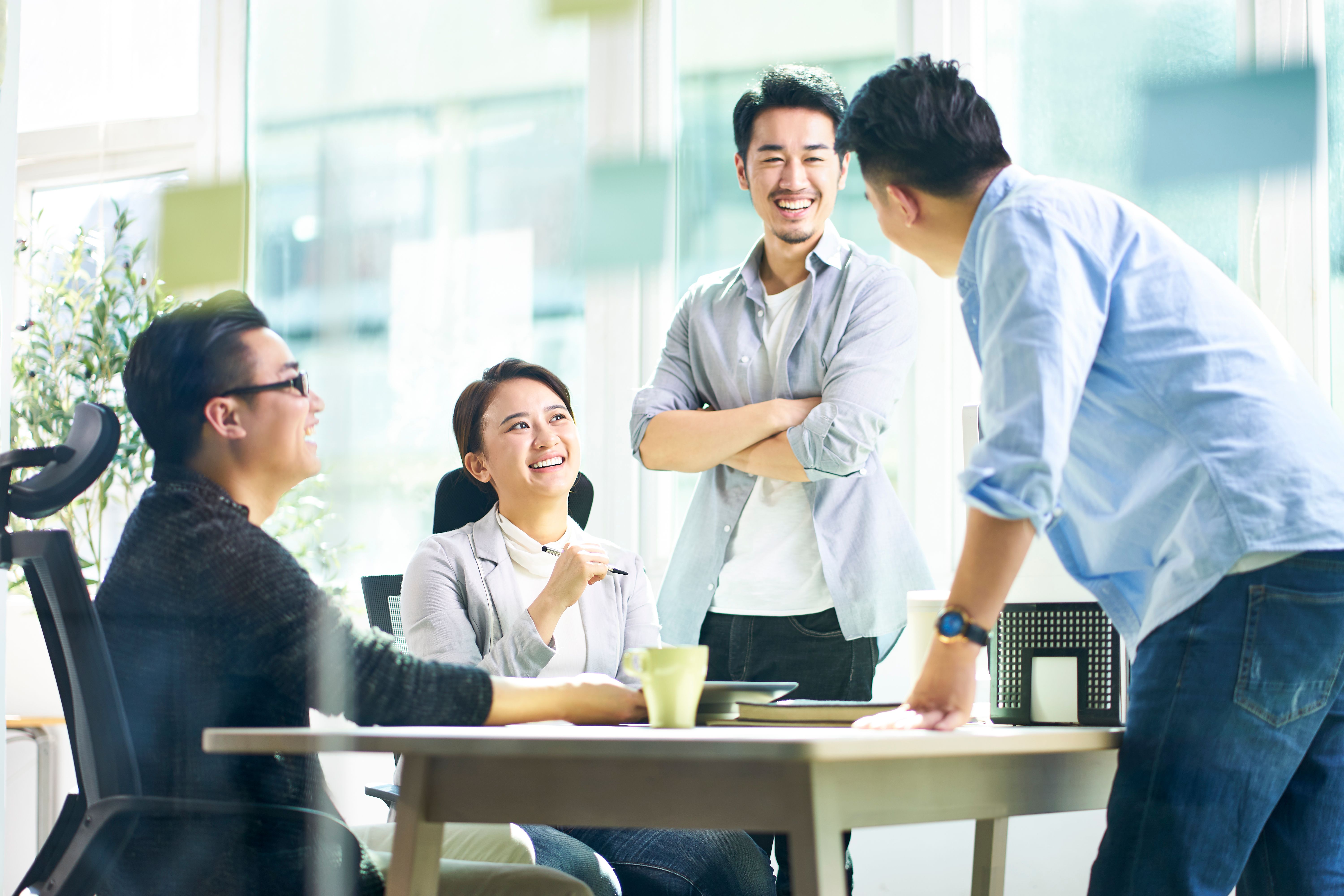 Group of young asian talking in offic