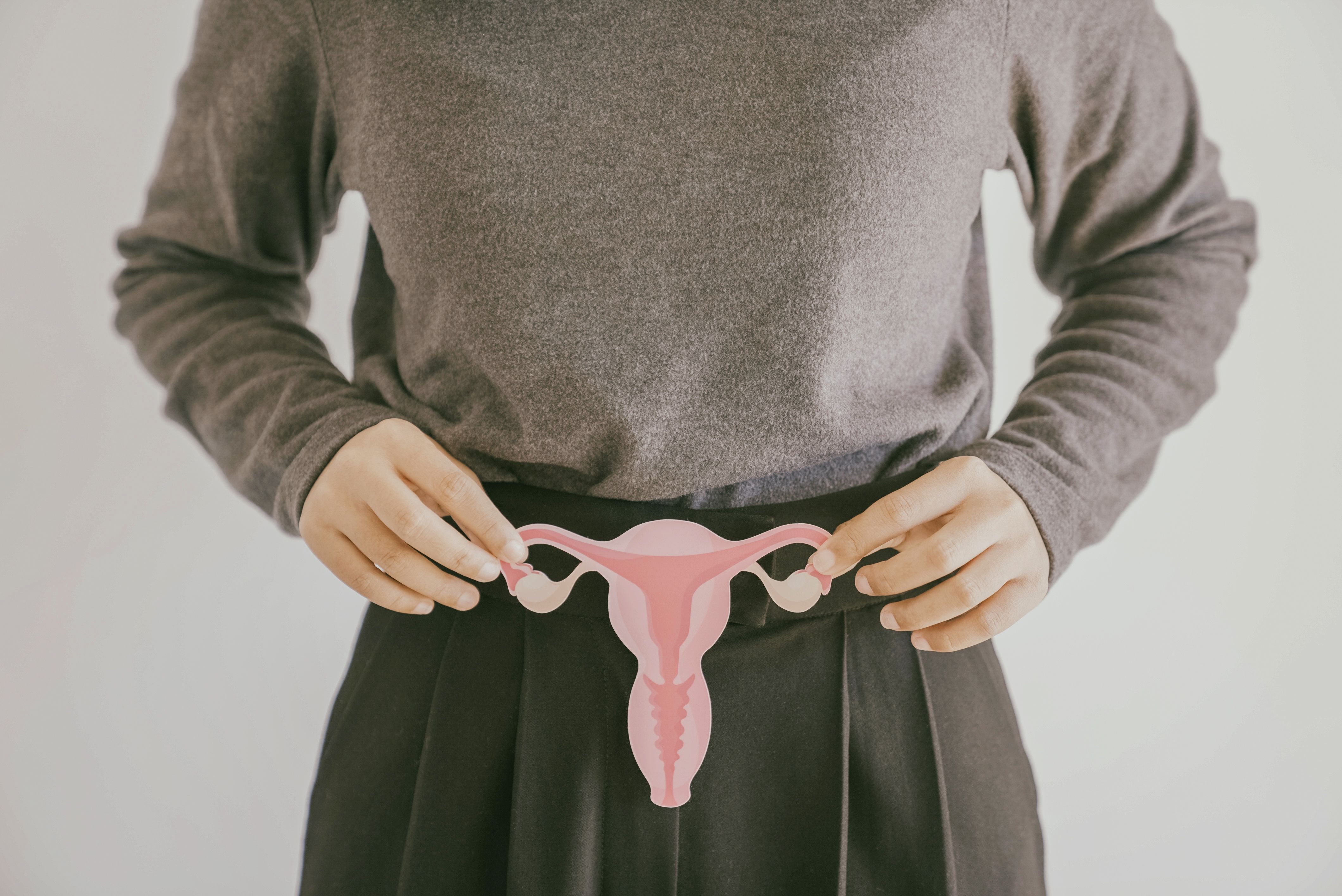 Woman holding picture of uterus